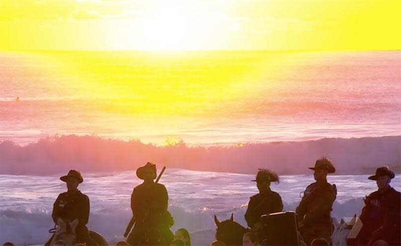 The rising sun greets the light horsemen as they stand guard along the shores of the Gold Coast. Source: AAP