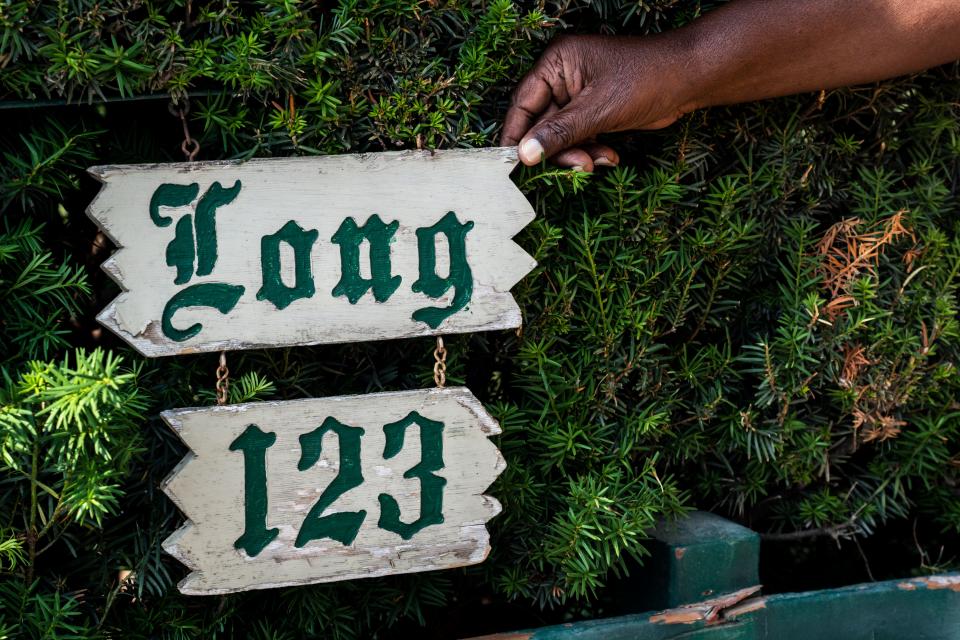 Gerry Page fixes the address sign on the Long home on Tuesday, June 27, 2023, in West Des Moines. 