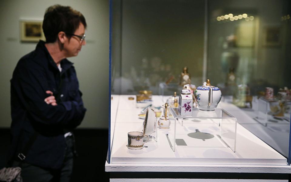 Kate Goudy from Ames, looks around the displayed tiny sculpture, paintings, and decorative arts from permanent collection display at Iowa State University's Brunnier Art Museum is scheman Building on Thursday, Feb. 22, 20924, in Ames