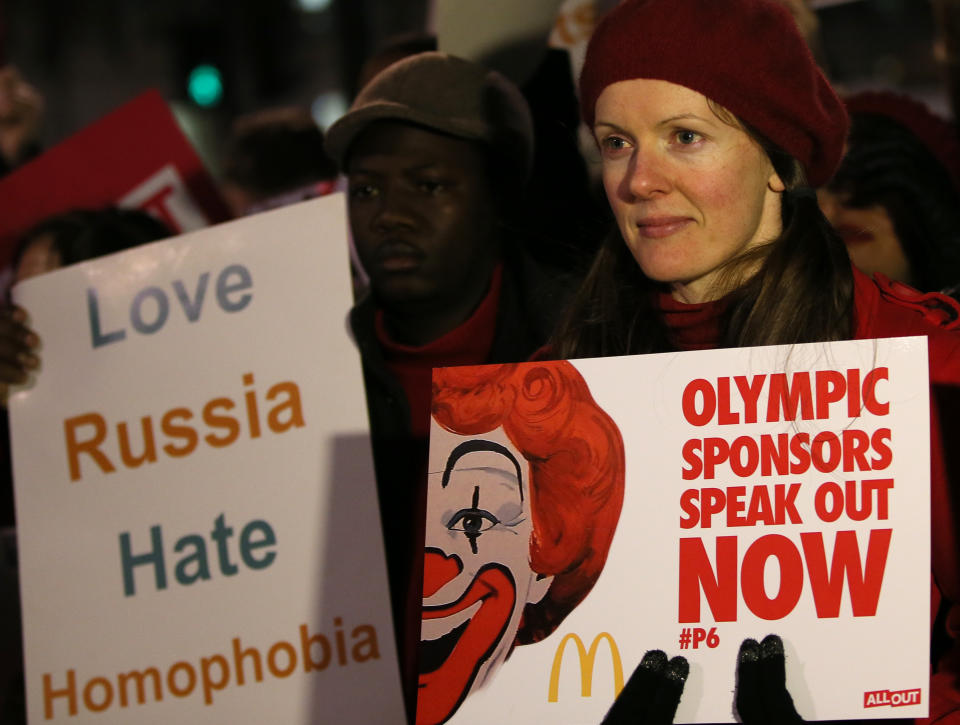 Lesbian and Gay Rights activists take part in a demonstration aimed to coincide with the upcoming Winter Olympics in Sochi, Russia, against laws aimed at stifling Gay Rights in Russia, opposite Downing Street in London, Wednesday, Feb. 5, 2014. In London, about 150 people rallying outside Prime Minister David Cameron's office in London urged McDonald's and the IOC's other sponsors to speak out. The activists there said they plan to deliver a petition signed by more than 100,000 people to a nearby McDonald's restaurant. (AP Photo/Alastair Grant)