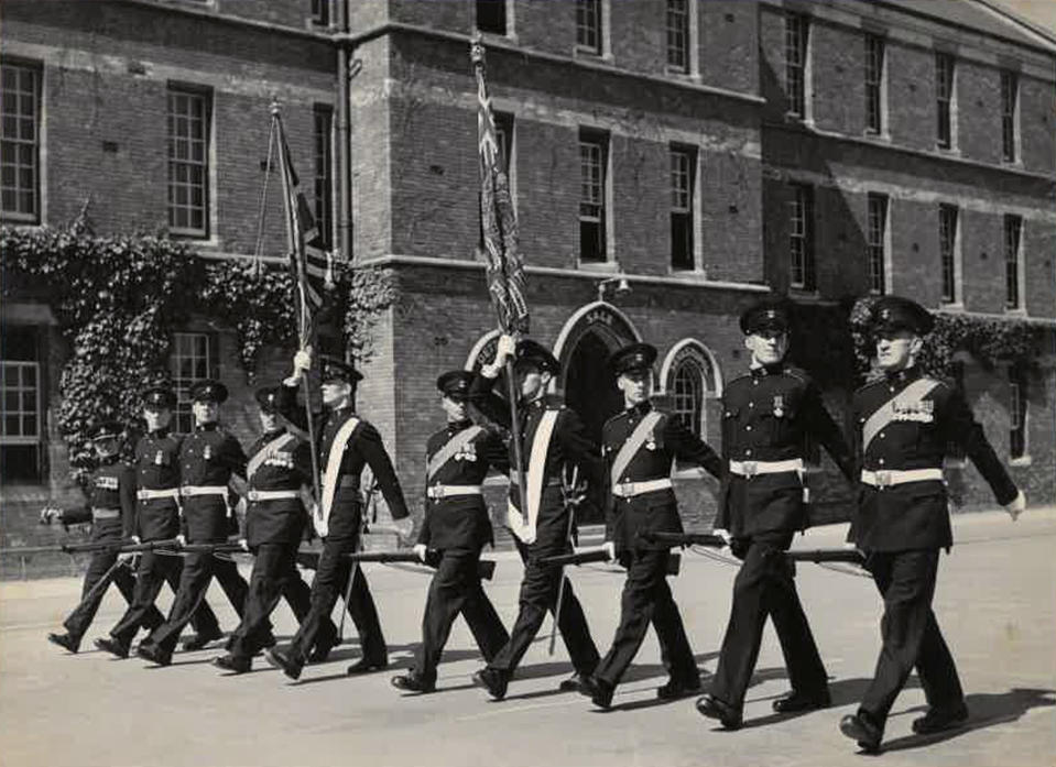 This photo provided by Susan Duddridge, shows her father Corporal David Hodge, second left marching at the Taunton Barracks, to prepare for the Coronation, in Taunton, England, 1953. Fresh from a posting in what was then known as Malaya, Hodge’s unit of the Somerset Light Infantry were positioned right behind the Tongan monarch’s carriage where he witnessed Queen Salote Tupou III riding in an open carriage during Queen Elizabeth's coronation parade in the rain, refusing to close the top as a sign of respect for the new monarch, (Susan Duddridge via AP)