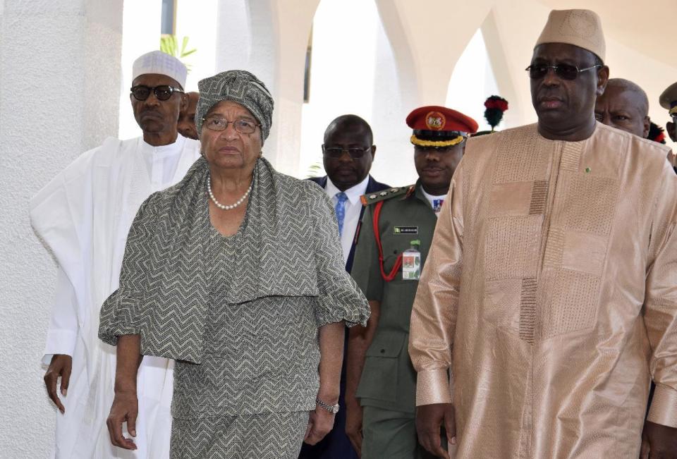 Nigeria President Muhammadu Buhari, left, Liberia President, Ellen Johnson Sirleaf, second left, and Senegal President Macky Sall, right, arrive for a meeting in Abuja, Nigeria, Monday, Jan. 9, 2017. Officials say Nigeria's President Muhammadu Buhari will lead three West African heads of state to Gambia on Wednesday in an effort to persuade its longtime leader to step down.(AP Photo/ Azeez Akunleyan)