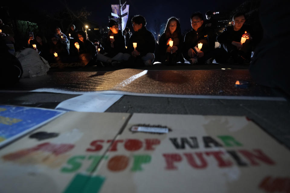 Protesters attend a vigil to mark the one-year anniversary of Russia's invasion of Ukraine, near the Russian Embassy in Seoul, South Korea, Friday, Feb. 24, 2023. (AP Photo/Ahn Young-joon)