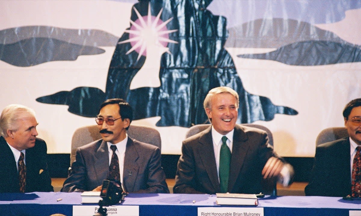 Paul Quassa, the premier of Nunavut from 2017 to 2018 and the Tungavik Federation of Nunavut’s chief negotiator during the talks to create Nunavut (left), sits with Prime Minister Brian Mulroney at the signing ceremony for the Nunavut Agreement in Iqaluit in May 1993. (Nick Newbery Photo Archives, Nunavut Archives - image credit)