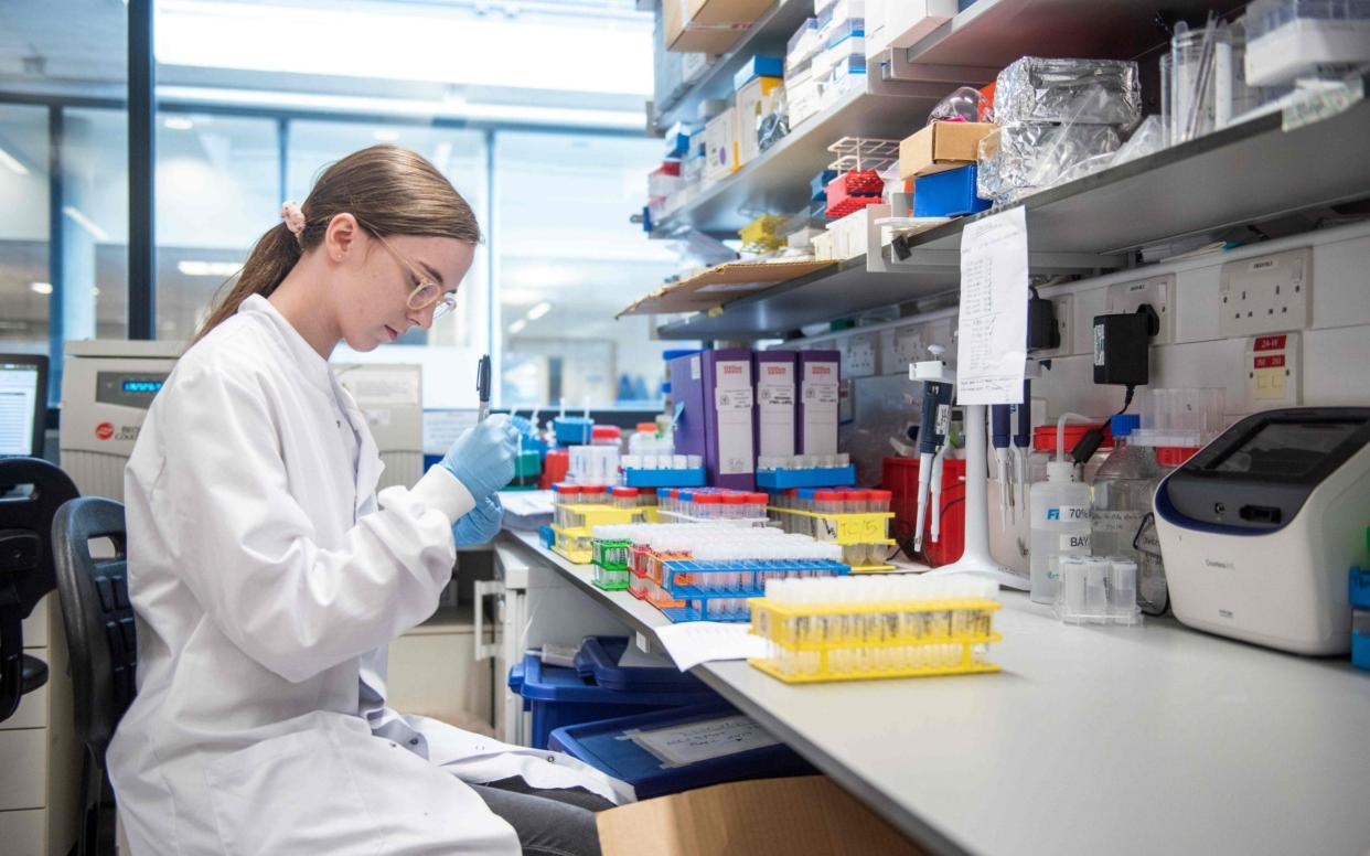 A technician working on the Oxford/AstraZeneca Covid vaccine - JOHN CAIRNS/University of Oxford/AFP via Getty Images