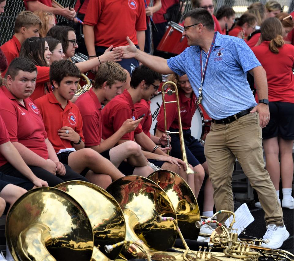 Steve Butcher interacts with band members prior to the West Holmes at Orrville football game last season. Butcher will be taking over as band director at West Holmes this year for the retiring Brian W. Dodd.