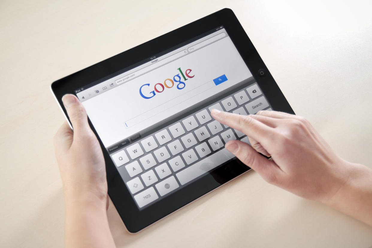 'Kiev, Ukraine - December 03, 2011: Woman hands holding and touching on Apple iPad2 with Google search web page on a screen. This second generation Apple iPad2 is designed and development by Apple inc. and launched in march 2011.'