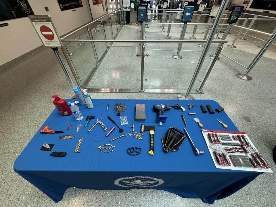 As part of a presentation by TSA at the Tallahassee International Airport, there was a table displaying items that had been voluntarily abandoned by previous passengers.