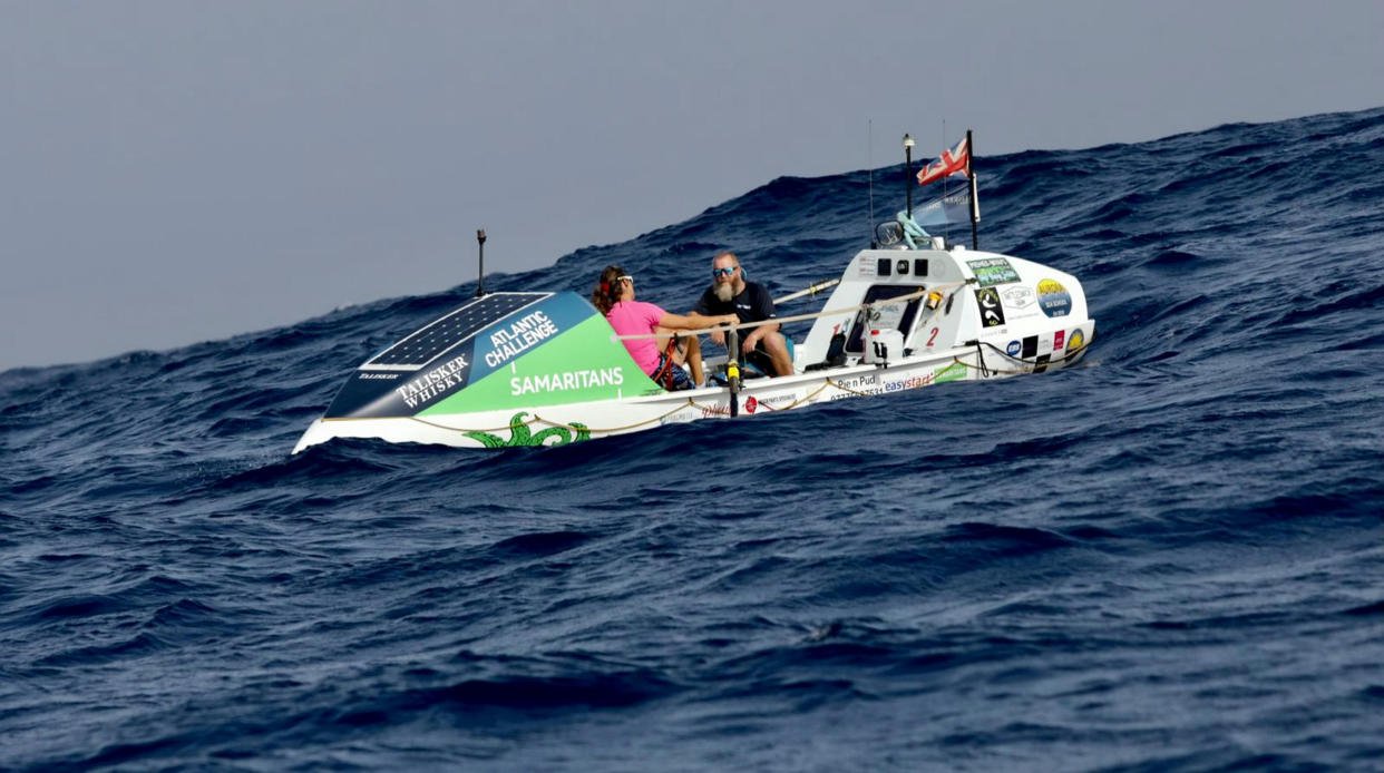Simon and Nina Crouchman rowing in their Kraken ocean rowing boat as they cross the Atlantic ocean. A couple who has spent two months rowing the Atlantic for charity is now appealing for help - because they can't afford to fly their boat home.  See SWNS story SWLNrowing.  Nina, 50, and Simon Crouchman, 53, have battled 14ft waves and a broken rudder to raise awareness and funds for the Samaritans.  The couple has pushed their marriage to the limits during the row, which has covered the entire length of the world's second-largest ocean - around 3,000 miles.  But the pair, from Colchester, Essex, now don't have enough to get themselves home from the finish line in Antigua - let alone their £65,000 boat.  They have so far raised £8,835 of their £50,000 target for Samaritans and are 60 days into their 65-day physical feat, dubbed the 'world's toughest row'. 
