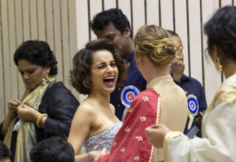 In this Tuesday, May 3, 2016, file photo, Bollywood actor Kangana Ranaut, center, gestures as she interacts with an unidentified person during the national film awards presentation ceremony in New Delhi, India. The entertainment capital of India may be reeling under the coronavirus onslaught, but its celebrity inhabitants are being roiled by troubles of another kind. The recent suicide of Sushant Singh Rajput, a young and popular movie actor in Mumbai has fueled a sustained reckoning over the privileges of the Bollywood elite, laying bare the simmering fault lines between the haves and the have-nots of the Hindi language movie industry. (AP Photo/Saurabh Das,file)