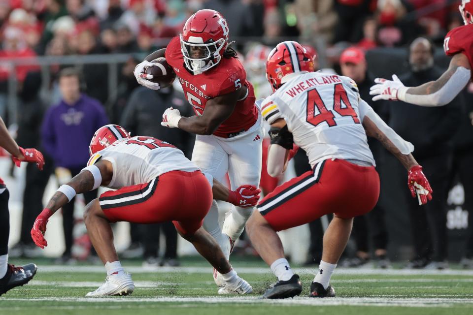 Nov 25, 2023; Piscataway, New Jersey, USA; Rutgers Scarlet Knights running back Kyle Monangai (5) gains yards after catch as Maryland Terrapins defensive back Dante Trader Jr. (12) and linebacker Caleb Wheatland (44) pursue during the first half at SHI Stadium. Mandatory Credit: Vincent Carchietta-USA TODAY Sports