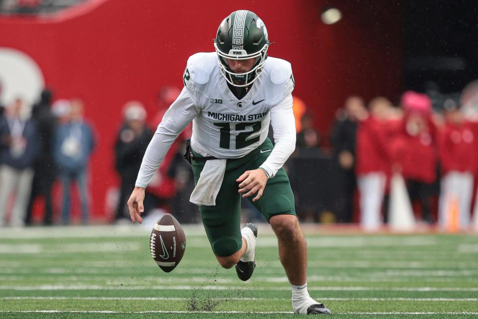 Michigan State Spartans quarterback Katin Houser recovers his own fumble for a first down during the first half against the Rutgers Scarlet Knights at SHI Stadium on October 14, 2023 in Piscataway, New Jersey.