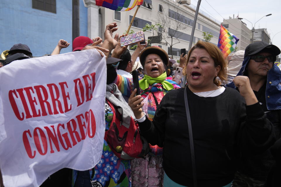 Supporters of Peruvian President Pedro Castillo rally with a flag that reads in Spanish "Closure of Congress" on the day of a planned impeachment vote on the president, near Congress in Lima, Peru, Wednesday, Dec. 7, 2022. Castillo dissolved the nation's Congress on Wednesday and called for new legislative elections, before lawmakers could debate a third attempt to remove him from office. (AP Photo/Martin Mejia)