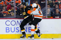 Philadelphia Flyers' Zack MacEwen, right, collides with Boston Bruins' Derek Forbort during the second period of an NHL hockey game, Wednesday, Oct. 20, 2021, in Philadelphia. (AP Photo/Matt Slocum)