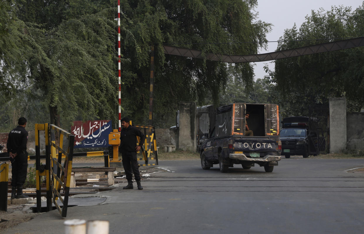 Police officers stand guard while police vehicle patrol at the vicinity of Kot Lakhpat prison, where Czech model Tereza Hluskova detain, in Lahore, Pakistan, Friday, Nov. 5, 2021. Hluskova, who was sentenced to eight years on charges of attempting to smuggle heroin from Pakistan to Abu Dhabi will be freed next week following her acquittal by an appeal court, a defense lawyer said Friday. (AP Photo/K.M. Chaudary)