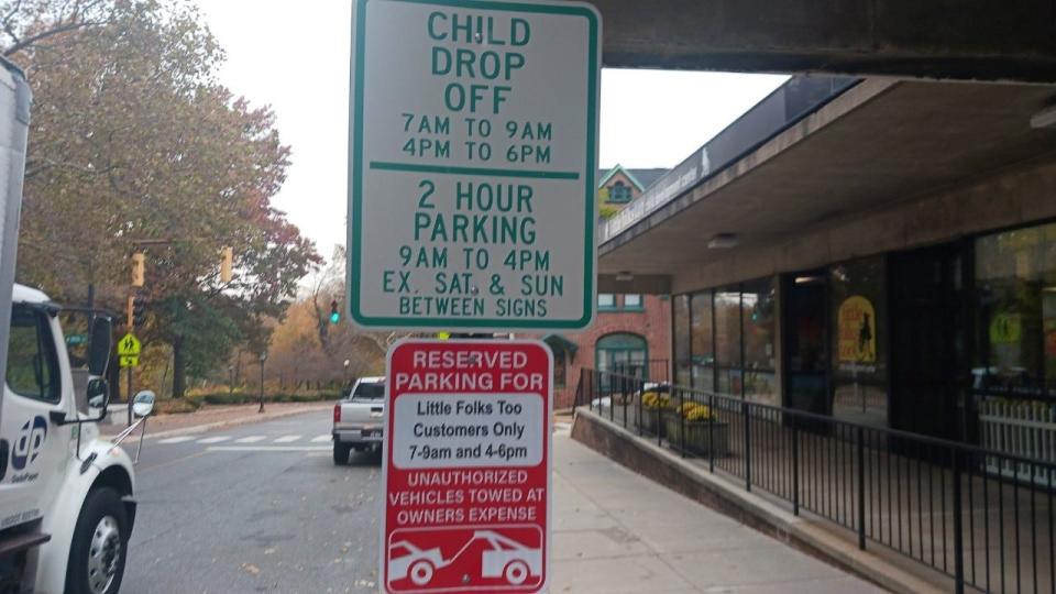 An illegally posted sign warning drivers that parking spaces were reserved for Little Folks Too Daycare was affixed to a city post outside of the North Market Street business in Wilmington. City officials removed the illegal sign on Monday, Nov. 13, 2023.