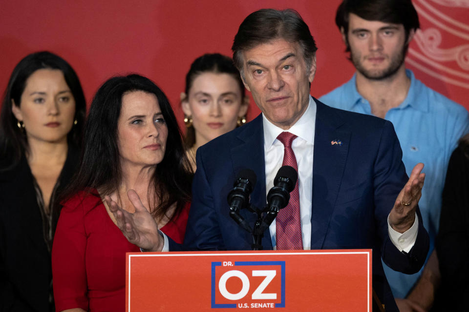 Mehmet Oz at the podium with his wife and family.