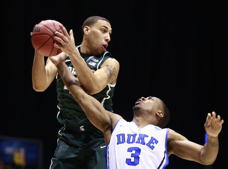 Duke Blue Devils guard Tyler Thornton (3) strips the ball away from Michigan State Spartans guard Denzel Valentine (45) in the first half during their Midwest Regional NCAA men's basketball game in Indianapolis, Indiana, March 29, 2013. REUTERS/Brent Smith
