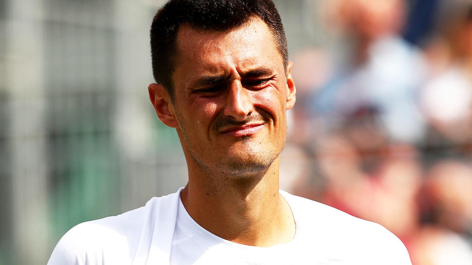 Bernard Tomic in action against Jo-Wilfried Tsonga at Wimbledon. (Photo by Clive Brunskill/Getty Images)