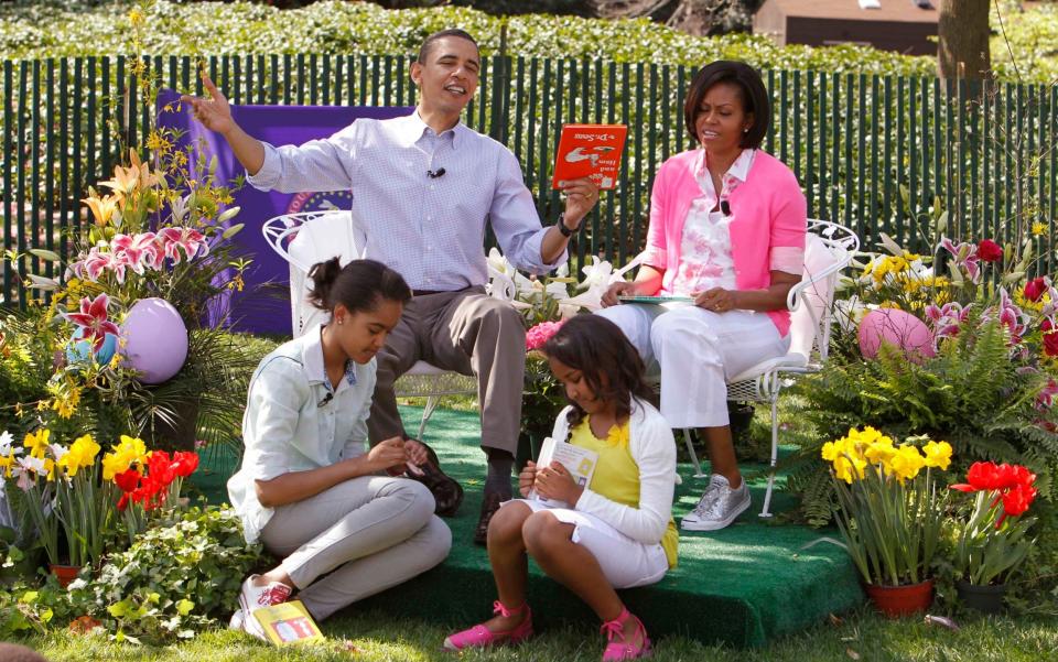 President Barack Obama holds "Green Eggs and Ham" by Dr. Seuss as he hosted the annual White House Easter Egg Roll, 2010 - Charles Dharapak /AP