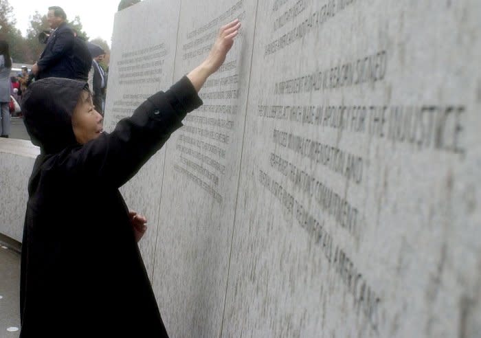A woman visits the National Japanese American Memorial during the dedication November 9, 2000, in Washington, D.C. The memorial is dedicated to the 120,000 Japanese Americans who were interned in camps and the 800 who died fighting during WWII. File Photo by Roger L. Wollenberg/UPI