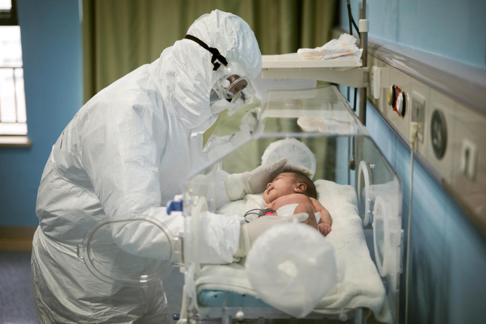 A medical staff attends to a baby with novel coronavirus at the Wuhan Children's Hospital, in Wuhan, the epicentre of the novel coronavirus outbreak, in Hubei province, China March 6, 2020. Picture taken March 6, 2020. (China Daily via Reuters) 