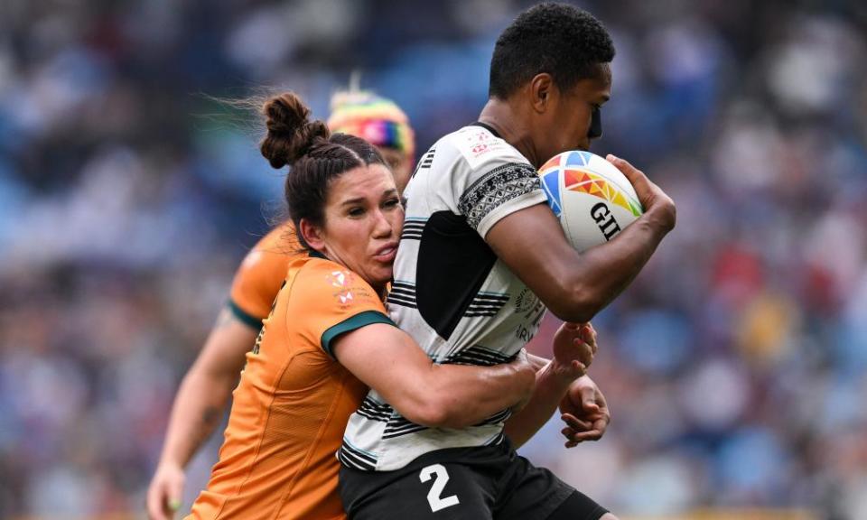 Australia’s Charlotte Caslick tackles Ivamere Nabura during the HSBC Sydney Sevens on Sunday