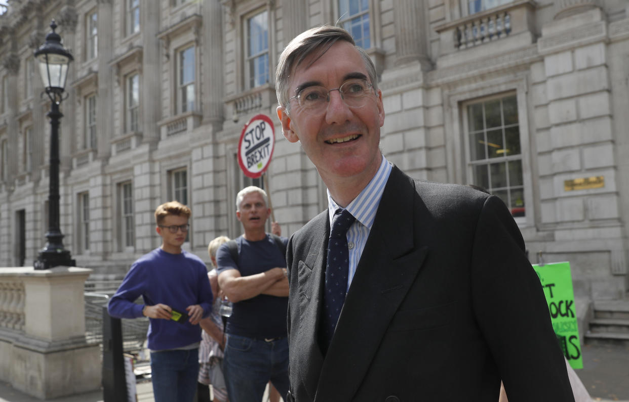 British lawmaker Jacob Rees-Mogg, Leader of the House of Commons, leaves the Cabinet Office in London, Monday, Sept. 2, 2019. Political opposition to Prime Minister Boris Johnson's move to suspend Parliament is crystalizing, with protests around Britain and a petition to block the move gaining more than 1 million signatures. (AP Photo/Alastair Grant)