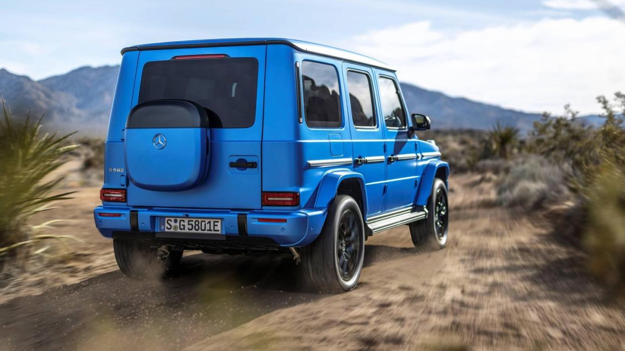 a blue 2025 mercedes g 580 with eq technology on a dirt road