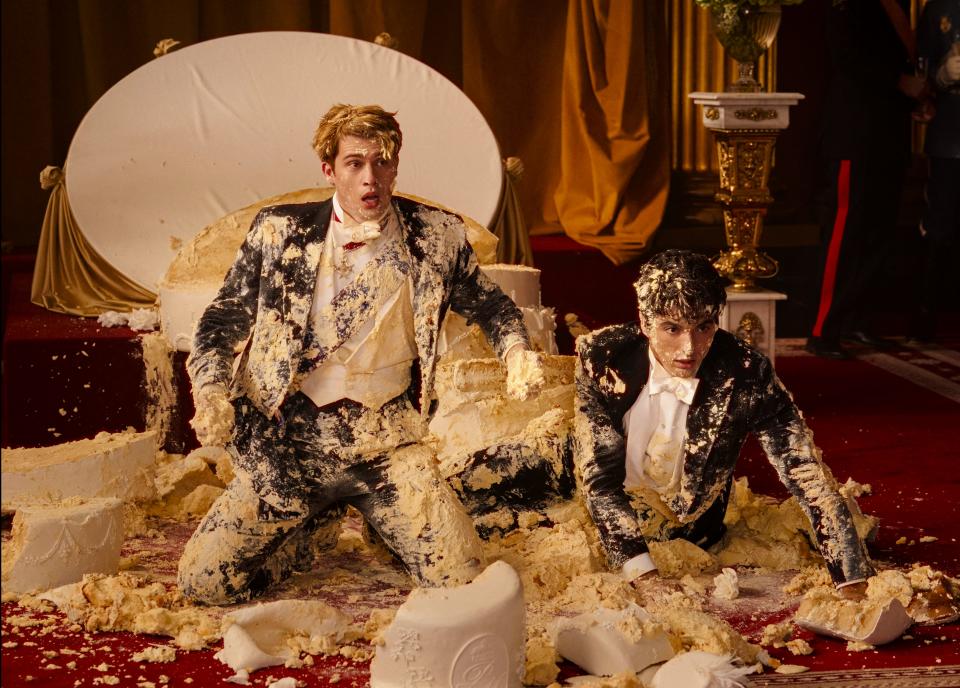 Prince Henry (Nicholas Galitzine, left) and presidential son Alex (Taylor Zakhar Perez) turn a wedding cake into an international incident in the romantic comedy "Red, White and Royal Blue."
