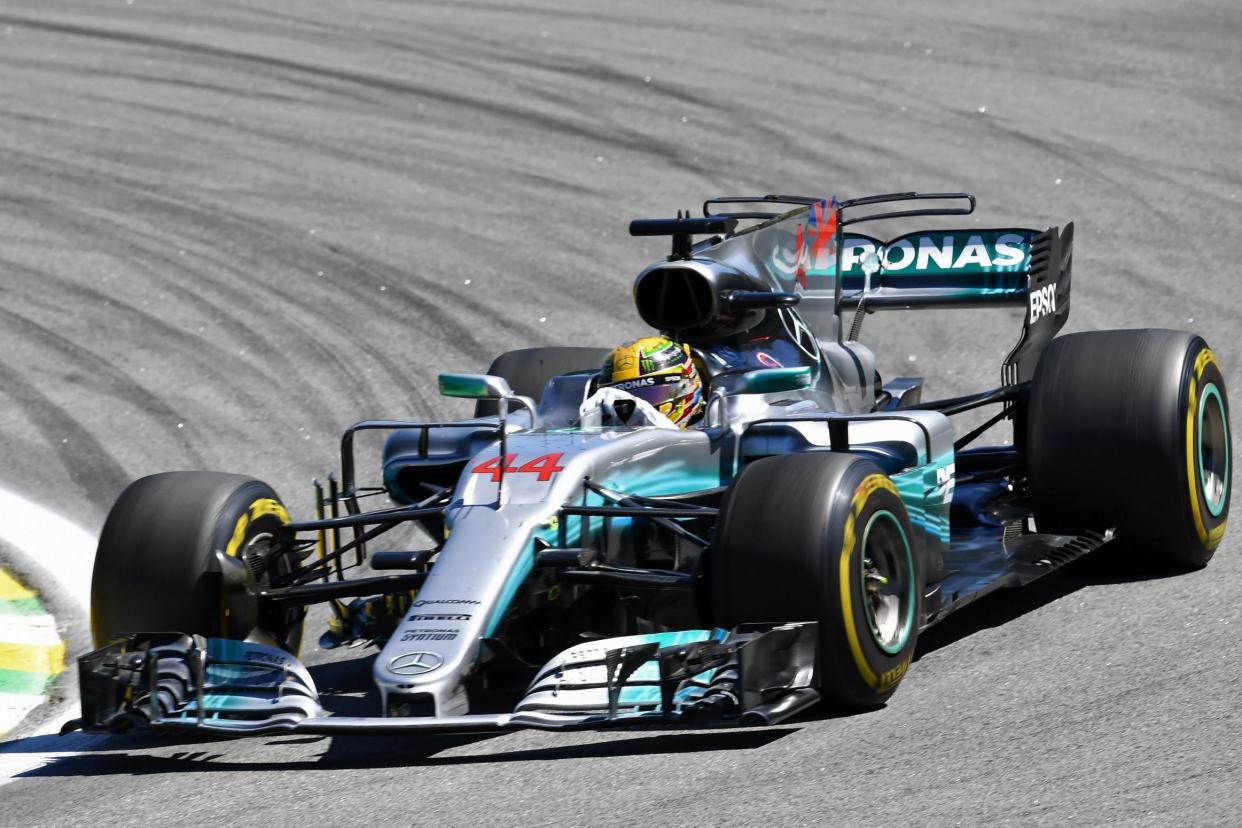 World beater: Lewis secured his fourth title at a canter this year although he was helped by Ferrari’s mistakes: AFP/Getty Images