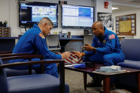 NASA commercial crew astronauts Victor Glover and Michael Hopkins talk over their flight procedures prior to a training flight in Houston, Texas