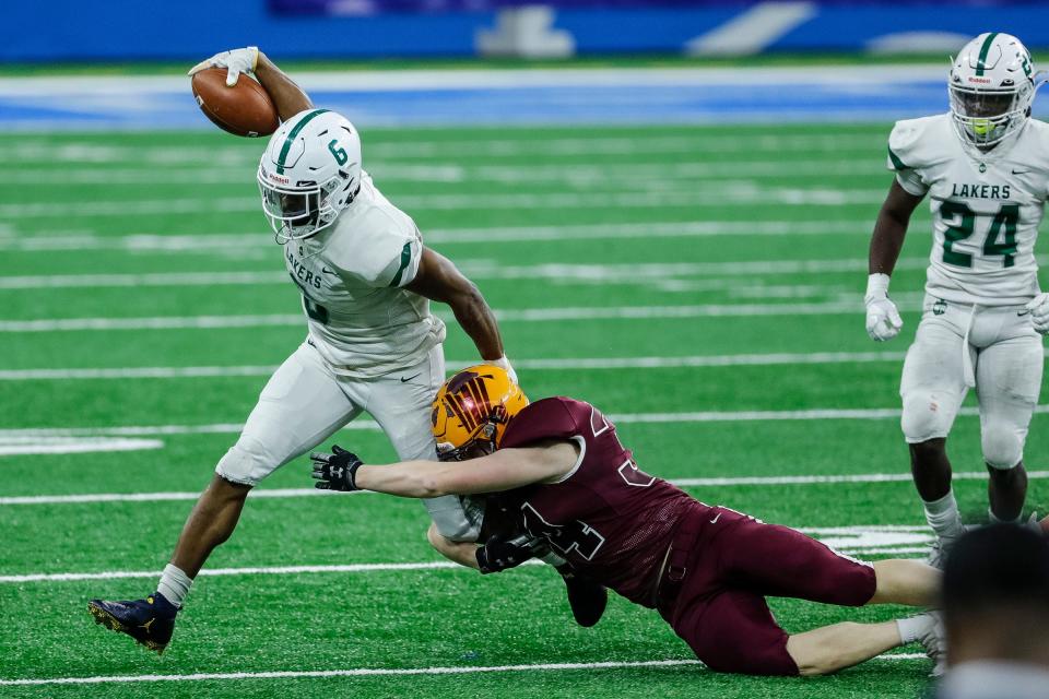 West Bloomfield running back Donovan Edwards runs against Davison defensive back Payton Pizzala during the first half of the MHSAA Division 1 final at Ford Field, Saturday, Jan. 23, 2021.