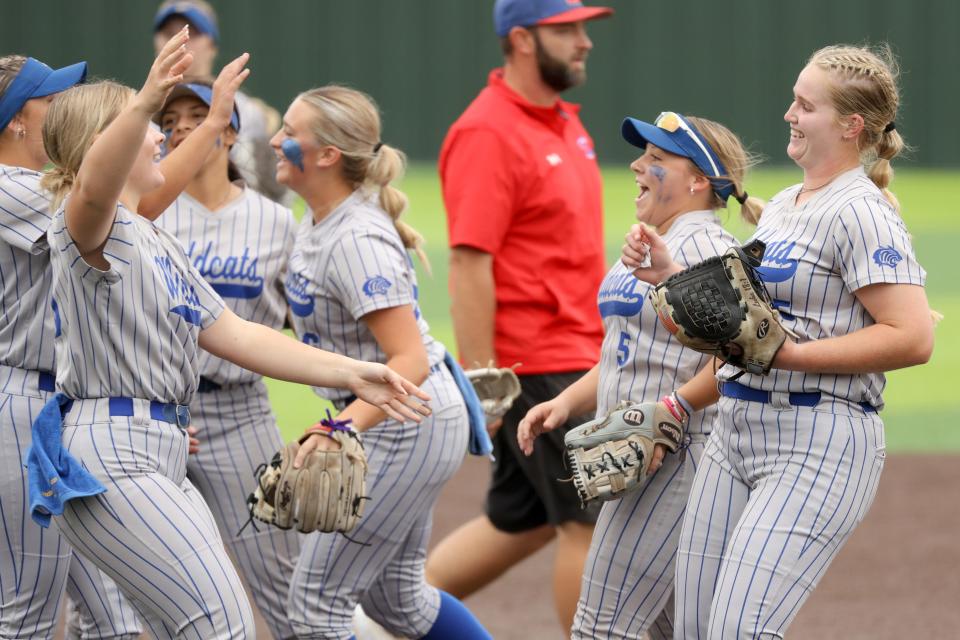 Piedmont's Payten Schibbelhute, right, and Catie Meyer, second from right, celebrate after a Class 5A state fastpitch softball game between Piedmont and Durant in Shawnee, Okla., Thursday, Oct. 12, 2023.