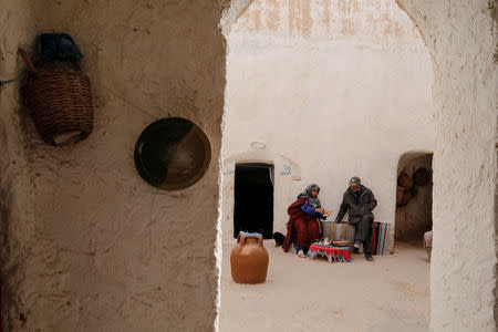 Mounjia, 60, serves brunch to her husband Tayeb, 76, at their troglodyte house in Matmata, Tunisia, February 6, 2018. REUTERS/Zohra Bensemra