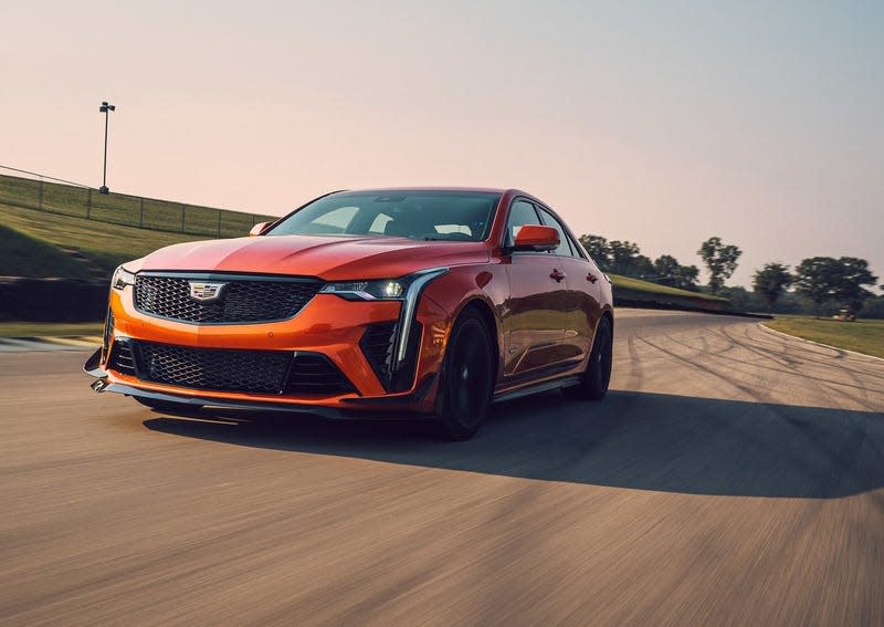 An orange Cadillac CT4 V Blackwing on a track