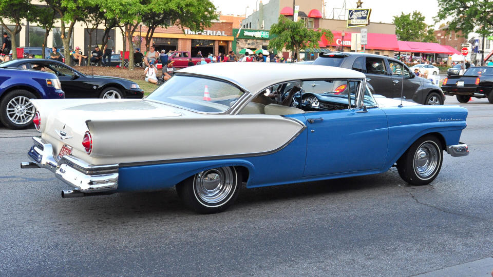 Ferndale, MI/USA-August 15 2015: 1957 Ford Fairlane car, back view, cruising the streets at the annual Woodward Dream Cruise; male driver.