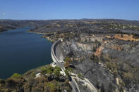 The blackened forests around Marathon Lake, which had been burned in a mid-August wildfire, are seen from above about 36 kilometres (22 miles) north of Athens, Thursday, Aug. 22, 2024. (AP Photo/Thanassis Stavrakis)