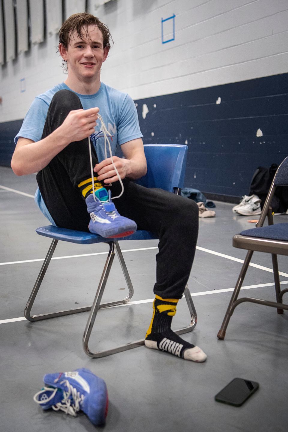 Connor Reese changes his shoes after wrestling practice at Roberson High School, February 13, 2024.