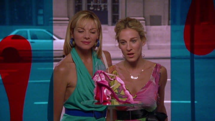 Kim Cattrall and Sarah Jessica Parker as Samantha and Carrie looking at a pair of shoes through a window in Sex and the City.