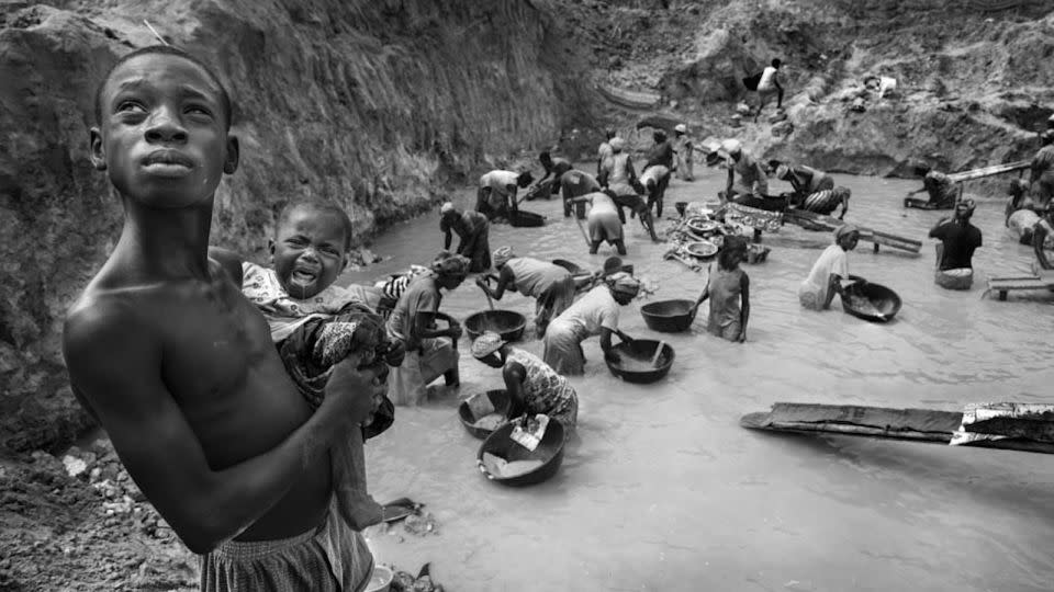 Panning for gold in Ghana, in water poisoned with mercury. - Lisa Kristine