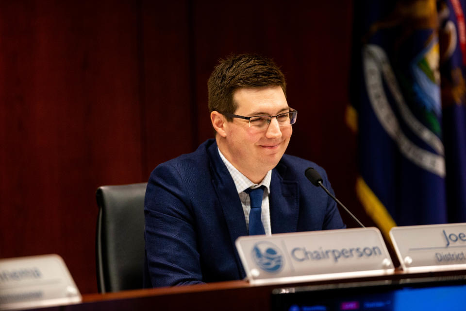 Commissioner Joe Moss cracks a smile as he listens to public comment Tuesday, Jan. 24, 2023, at the County Offices in West Olive. 