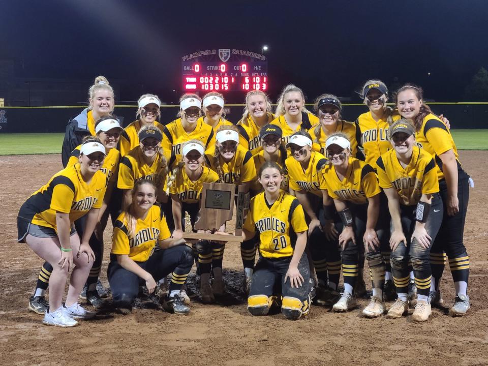 Avon softball players pose with the IHSAA sectional trophy after beating Terre Haute North, 10-6, at Wednesday at Plainfield.