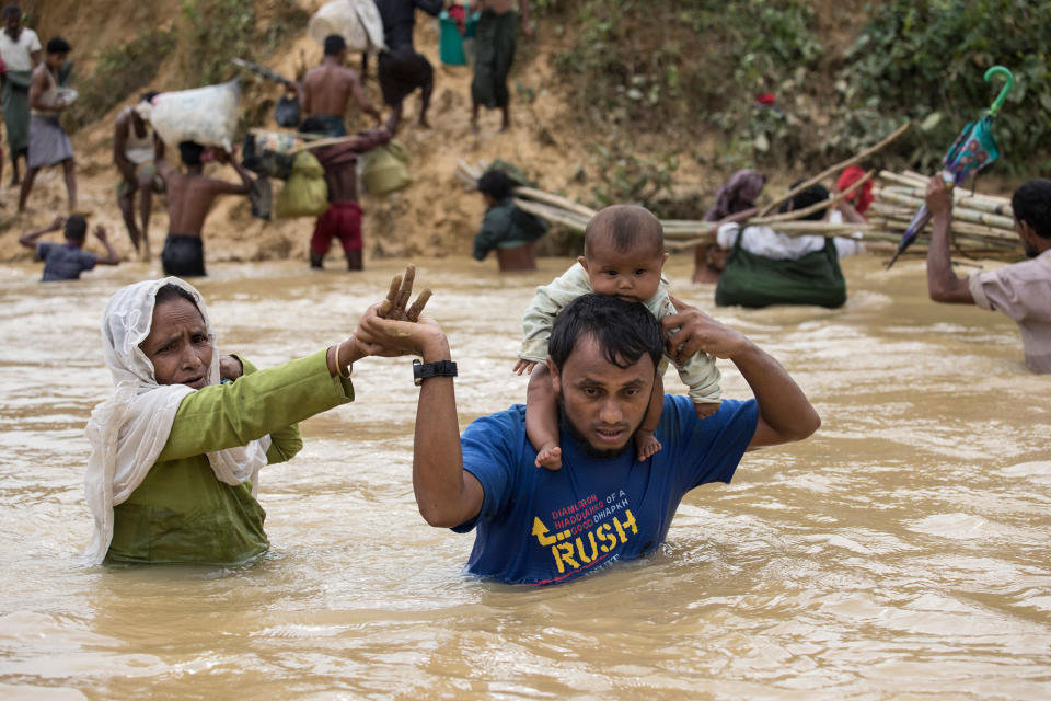 <p>Rohingya desperately try to cross a river on a crowded makeshift bamboo bridge at Kutpalong camp on September 20, 2017. (Photograph by Paula Bronstein/UNHCR) </p>