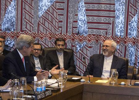 U.S. Secretary of State John Kerry (L) and Iranian Foreign Minister Mohammad Javad Zarif (R) are seated during a meeting of the Foreign Ministers representing the permanent five member countries of the United Nations Security Council plus Germany on the sidelines of the UN General Assembly at the UN Headquarters in New York September 26, 2013. REUTERS/Brendan McDermid