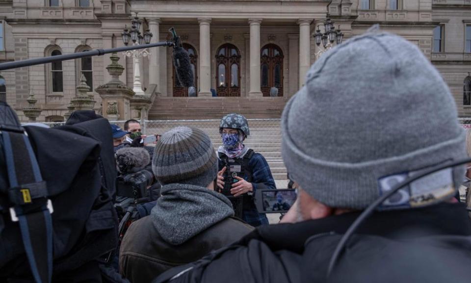 A member of the Boogaloo Bois, an anti-government group, speaks to the press in front the Capitol building in Lansing, Michigan, on Sunday.