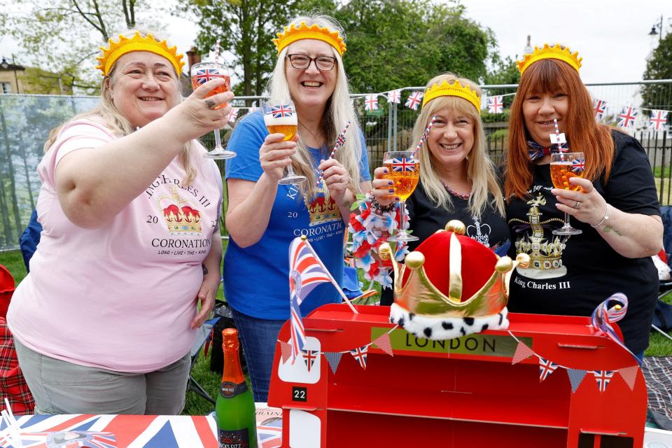 People hold drinks during a picnic in a garden at Windsor Castle, a day after the coronation of Britain's King Charles, in Windsor (Reuters)