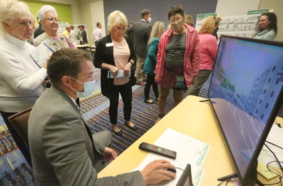 Scott Barr with Ghyabi-White Consulting and Management shows residents a video of some of the conceptual roadway improvements for beachside at the Ocean Center in Daytona Beach on Wednesday.