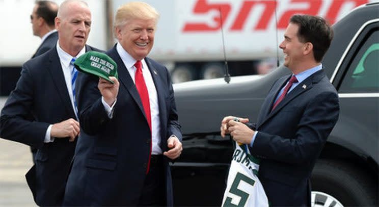 Trump flashes a smile as Wisconsin governor Scott Walker gifts the President with a Bucks-themed MAGA hat. (Twitter/@ScottWalker)