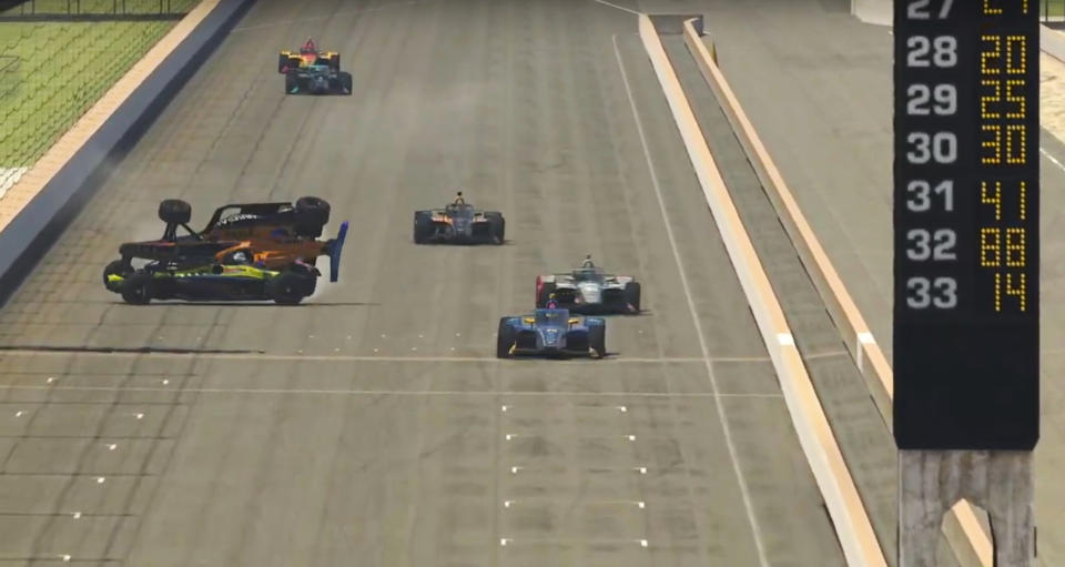 In this image taken from video provided by iRacing IndyCar, drivers Oliver Askew (orange) and Santino Ferrucci, left, collide on the final stretch allowing Scott McLaughlin, right, to win the First Responder 175 presented by GMR virtual IndyCar auto race at the Indianapolis Motor Speedway, Saturday, May 2, 2020, in Indianapolis, Ind. (iRacing IndyCar via AP)
